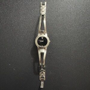 Movado silver tone women's watch with black face and bracelet watch.